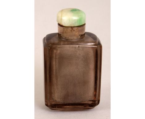 A CHINESE SMOKY GLASS SNUFF BOTTLE, and incomplete apple-green jade stopper, 2.4in high.