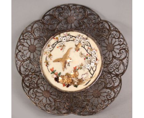 A SIGNED JAPANESE MEIJI PERIOD SHIBAYAMA IVORY & SILVER METAL PLAQUE, decorated to its ivory centre with a bird in flight bes