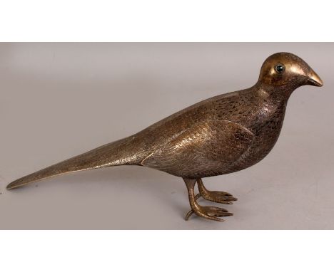 A 19TH/20TH CENTURY PERSIAN SILVERED METAL MODEL OF A STANDING BIRD, its coat naturalistically engraved, its eyes inlaid with