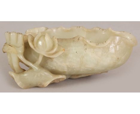 A 19TH CENTURY CHINESE CELADON JADE LOTUS BRUSHWASHER, the stone with some paler inclusions, 5.4in long & 2.4in high.