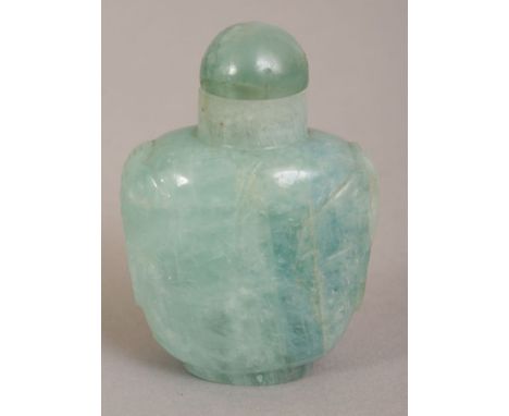 AN UNUSUAL CHINESE JADE SNUFF BOTTLE & BOWENITE STOPPER, the stone of pale blue tone with lighter inclusions, 1.9in high.