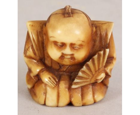 A SMALL JAPANESE MEIJI PERIOD NETSUKE OF A KNEELING SAMURAI, bearing a fan, 1in wide at widest point & 1.1in high.