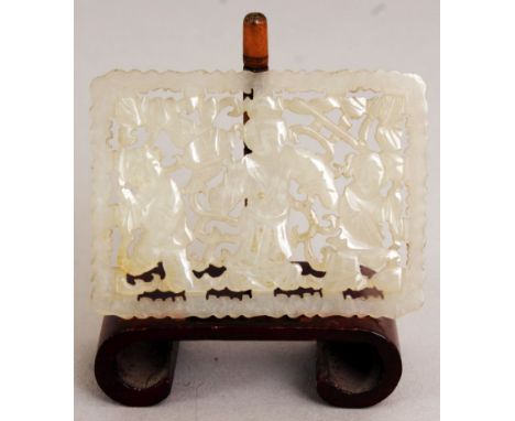 A SMALL CHINESE RECTANGULAR PIERCED CELADON JADE PLAQUE, together with a wood display stand, decorated with an Immortal in th