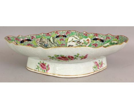 A GOOD QUALITY 19TH CENTURY CHINESE CANTON SHAPED OVAL DISH, supported on a high flared foot, the interior painted with figur