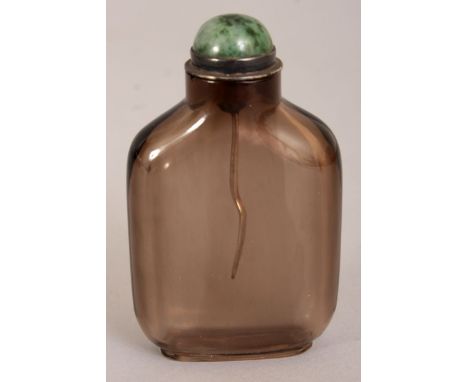 A CHINESE SMOKY GLASS SNUFF BOTTLE & MOTTLED GREEN JADE STOPPER, 2.9in high.