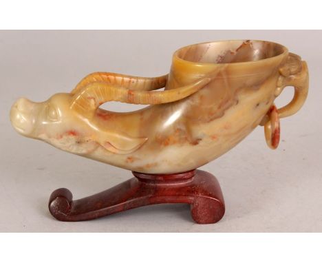 AN UNUSUAL GOOD QUALITY EARLY 20TH CENTURY CHINESE CARVED SOAPSTONE RHYTON CUP, on an integral scroll stand, the cup with loo
