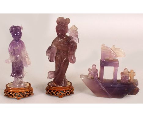 A 20TH CENTURY CHINESE AMETHYST CARVED FIGURE OF GUANYIN, together with a fixed wood stand, 4.7in high overall; together with
