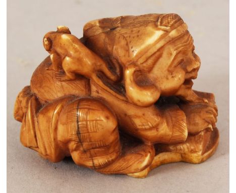 A JAPANESE MEIJI PERIOD STAINED IVORY NETSUKE OF DAIKOKU, squatting before a box and with a rat on his shoulder, 1.6in long &