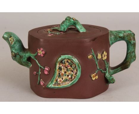 A 19TH CENTURY CHINESE ENAMELLED YIXING POTTERY TEAPOT & COVER, the sides moulded in relief with a tear-form panel, a mask an