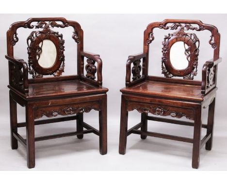 A GOOD PAIR OF EARLY 20TH CENTURY CHINESE CARVED HARDWOOD ARMCHAIRS, each with a hardwood framed marble back panel, each arm 