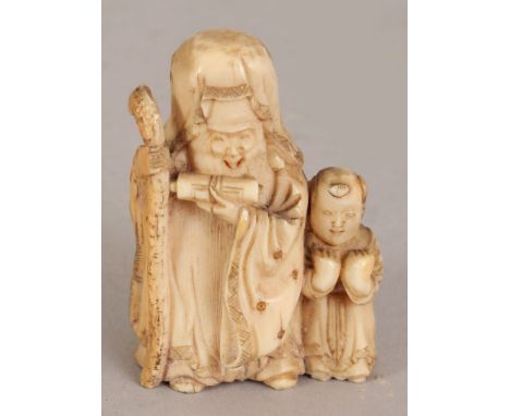 A JAPANESE MEIJI PERIOD IVORY NETSUKE OF FUKUROKUJU, bearing a scroll and staff and in the company of a small boy, 1.9in high