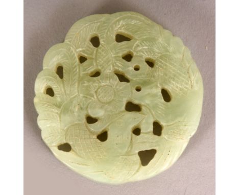 A CHINESE CELADON GREEN PIERCED JADE PLAQUE, carved with a pair of phoenix, 1.9in diameter.