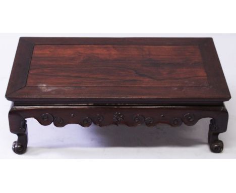 ANOTHER 19TH CENTURY CHINESE HARDWOOD LOW TABLE, with a rectangular top over an undulating frieze carved with scroll motifs a