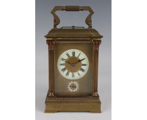 A late 19th century French brass carriage alarm clock with eight day movement repeating and striking hours and half hours on 
