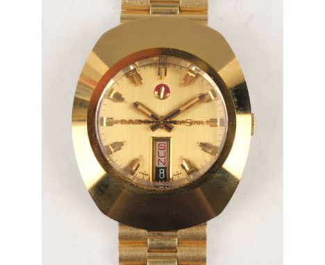 A Rado Diastar 13-G gilt metal fronted and steel backed gentleman's bracelet wristwatch, the signed gilt dial with day and da