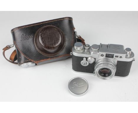 A Leica IIIg camera, Nr. 956 455, circa 1959, with Elmar f=5cm 1:2.8 lens, leather cased.Buyer’s Premium 29.4% (including VAT