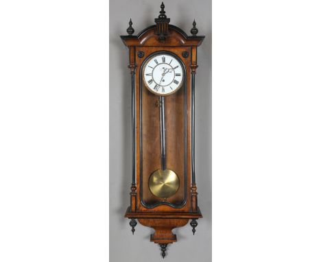 A late 19th century walnut and ebonized Vienna style wall clock with single train movement, the two piece enamel dial with Ro