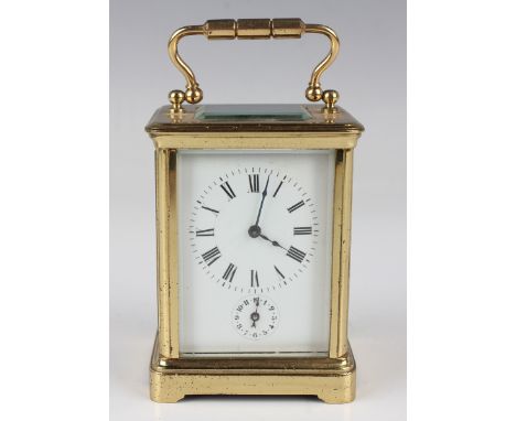 An early 20th century French lacquered brass diminutive carriage alarm clock with eight day movement striking on a bell, the 