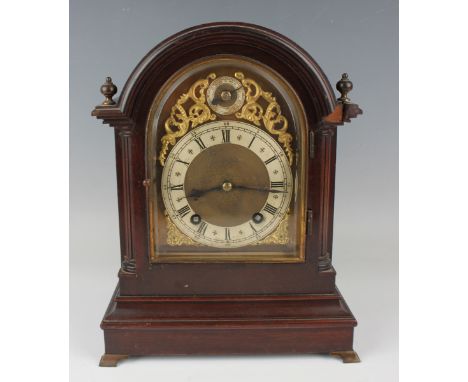 An early 20th century mahogany mantel clock with eight day movement striking hours and quarters on two gongs, the backplate s