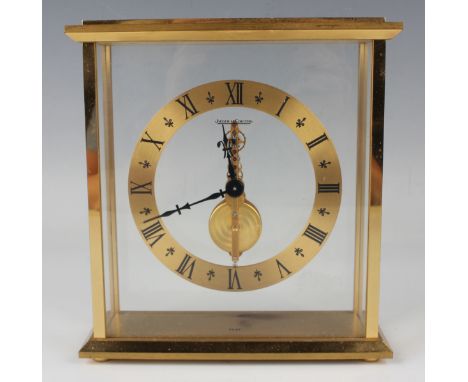 A Jaeger-LeCoultre gilt brass mantel timepiece, the brass chapter ring with black Roman hour numerals surrounding the signed 