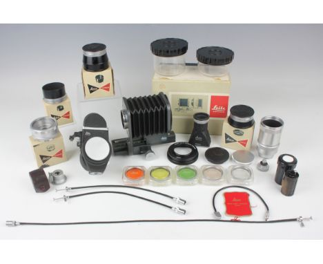 A collection of Leitz Wetzlar Leica camera accessories, including a 16556 P camera lens close focus bellows, boxed, an OTZFO 