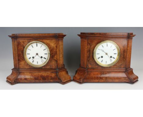 A near pair of late 19th century French walnut cased mantel clocks, each with eight day movement striking on a bell, the whit