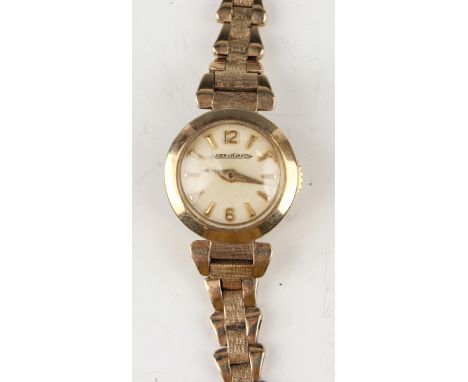 A Jaeger-LeCoultre 9ct gold cased rear winding lady's bracelet wristwatch, the signed silvered dial with gilt baton hour mark