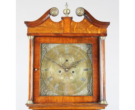 A George III oak and mahogany crossbanded longcase clock with eight day movement striking on a bell, the 12-inch square brass