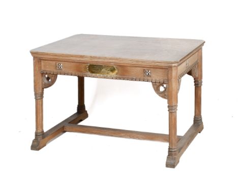 A late 19th century Gothic Revival oak library table. Of rectangular canted form, above arched carved and pierced brackets, o