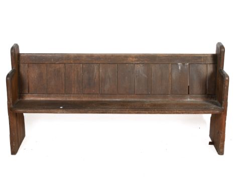 A late 19th century short pitch pine church pew. Chamfered end pieces, panelled back and single piece seat. H87cm x W176cm x 