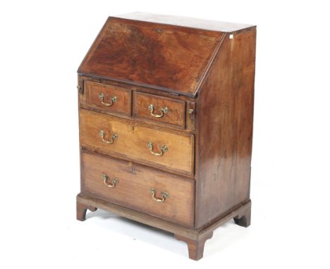 A small 19th century mahogany bureau. With a fitted interior enclosed by a fall-front above two short and two long graduated 