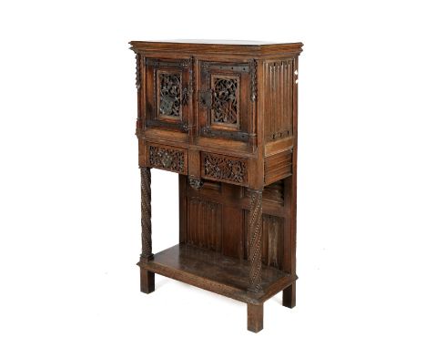 An 18th century English oak Jacobean style carved cabinet. Raised above storage shelf with heavily detailed carved panels. H1