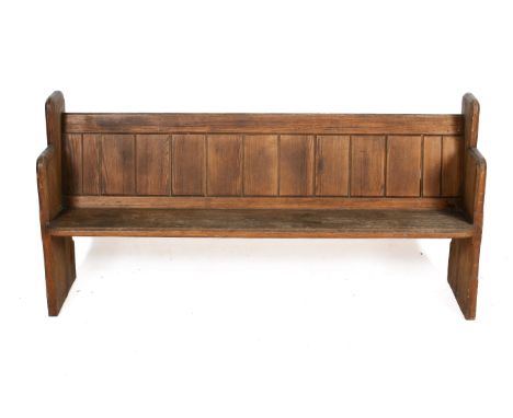 A late 19th century short pitch pine church pew. Chamfered end pieces, panelled back and single piece seat. H87cm x W176cm x 