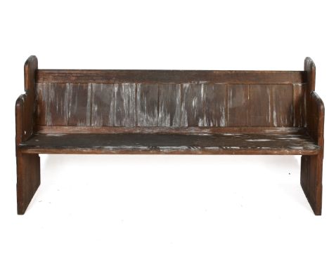 A late 19th century short pitch pine church pew. Chamfered end pieces, panelled back and single piece seat. H87cm x W176cm x 