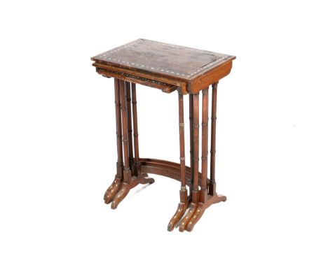 A nest of three early 20th century rosewood tables. The rectangular tops mounted on faux bamboo supports united by curved str