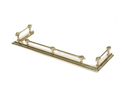 A Victorian brass fire fender. Mounted on a stepped base, H15cm x W114cm x D37cm
