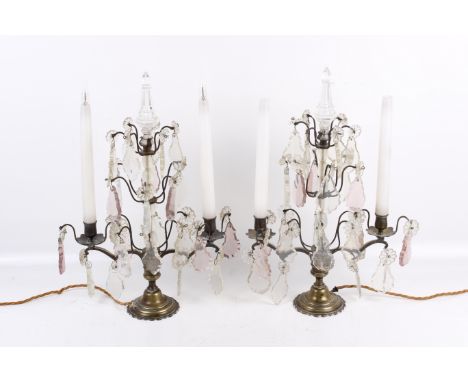 A pair of 19th century French candelabra. Having two branches, decorated with crystal pendalogue lustres and topped by a crys