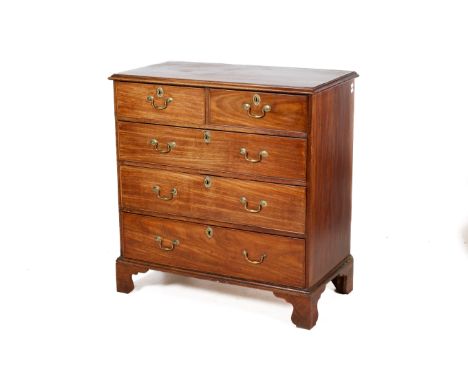 A Georgian mahogany chest of drawers. Having two short over three graduated drawers with later brass fittings. Raised on brac
