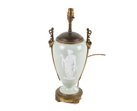 A 19th century bronze and porcelain table lamp. The vase form lamp glazed in green celadon and featuring pâte-sur-pâte relief