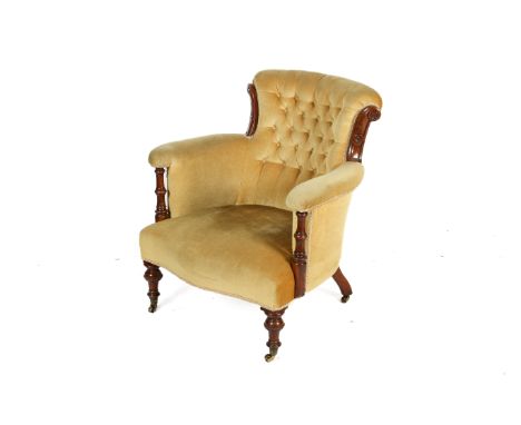 A Victorian button backed bedroom chair. With mahogany frame, on turned supports and casters, with mustard coloured upholster