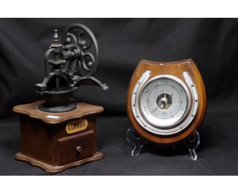 A coffee grinder and a horse shoe SB barometer.