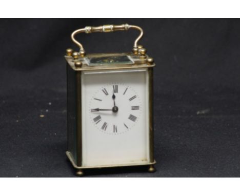 A brass carriage clock.