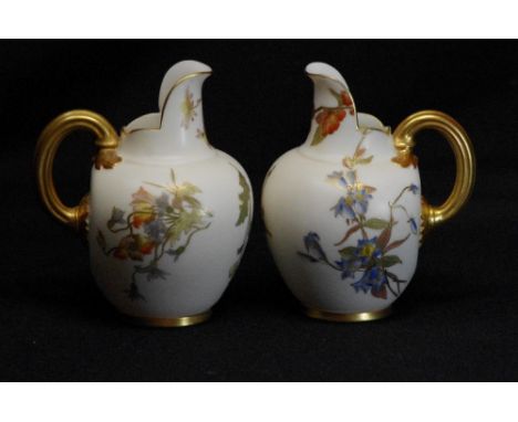 A pair of Royal Worcester blush ivory flat back jugs decorated with Art sprays designed by Edward Raby and Frank Roberts, cir