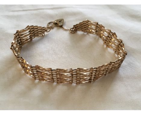 A 9ct gold gate bracelet with safety chain and padlock, approximate weight 5.3 grams.