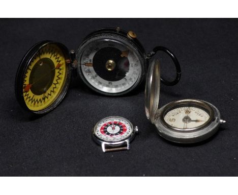 Two pocket compasses, one stamped "The Magnapole" Series II and a silver plate cased pocket compass; also a 1970s Timex Bulls