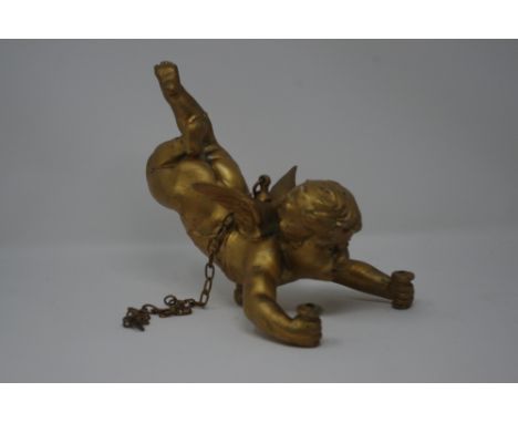 A gilt decorated suspended cherub with hanging chain.
