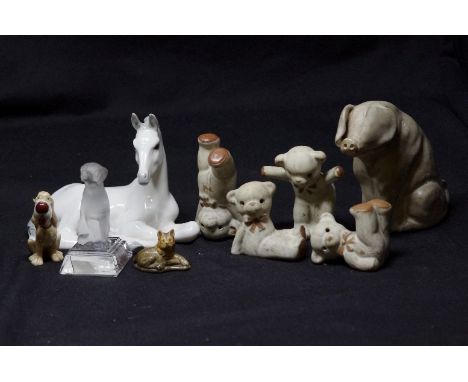 An assortment of glass and ceramic animals including a Beswick spaniel, Wade, a recumbent pony from the U.S.S.R. etc.