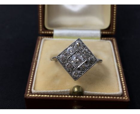 An Art Deco platinum set nine stone diamond panel ring, the centre stone approximately 0.25cts, size O, approximately 3.7 gra