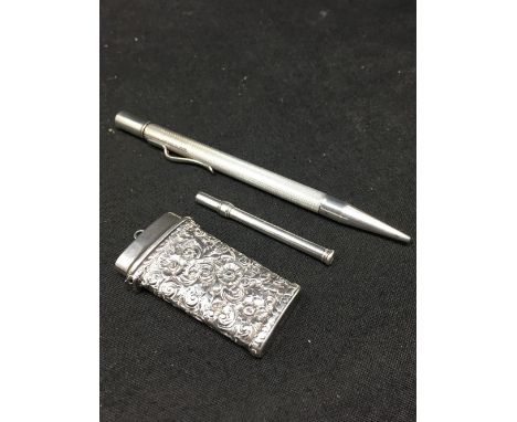 A silver retractable tooth pick, a Georgian silver embossed vesta case, Birmingham hallmark, and a sterling silver propelling