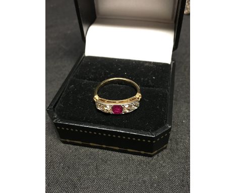 An 18ct gold Art Deco five stone diamond and ruby dress ring, the centre stone flanked by four diamonds, size L, approximatel